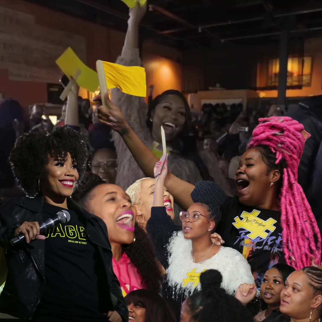 The crowd cheering, waving yellow hashtag signs