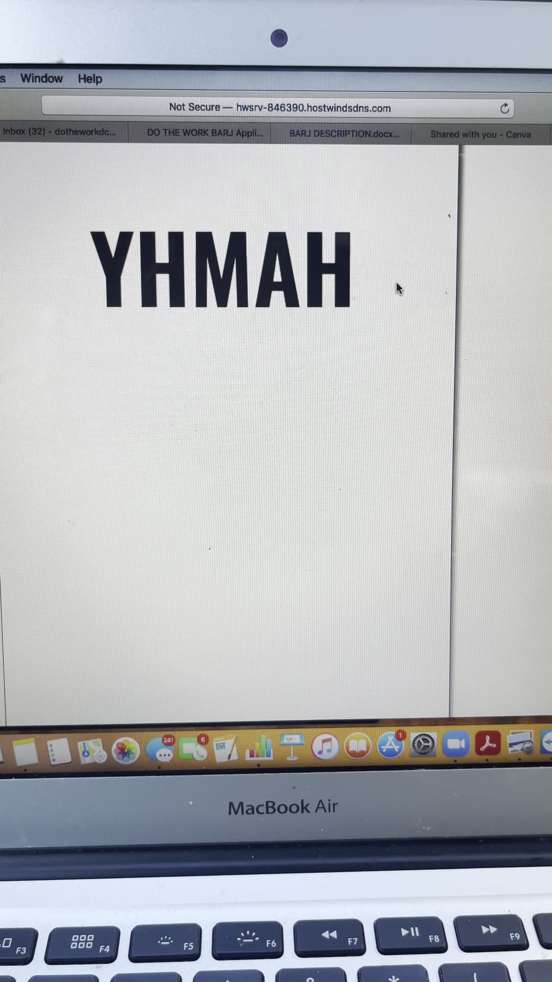 A laptop running the online game: the acronym YHMAH on screen with a player chat beside it