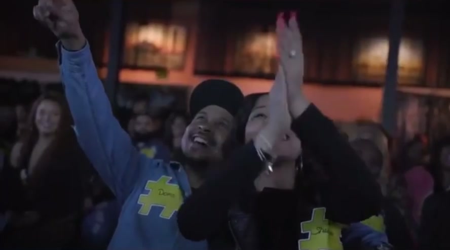 Audience members cheering in CultureTags hashtag shirts