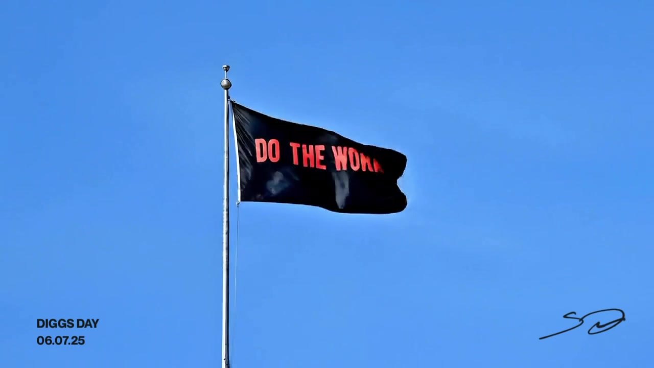 A DO THE WORK flag flying over Diggs Day