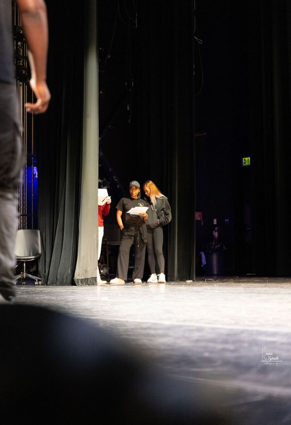 DOTHEWORK crew in the wings at MWMP Live!, reading the run sheets