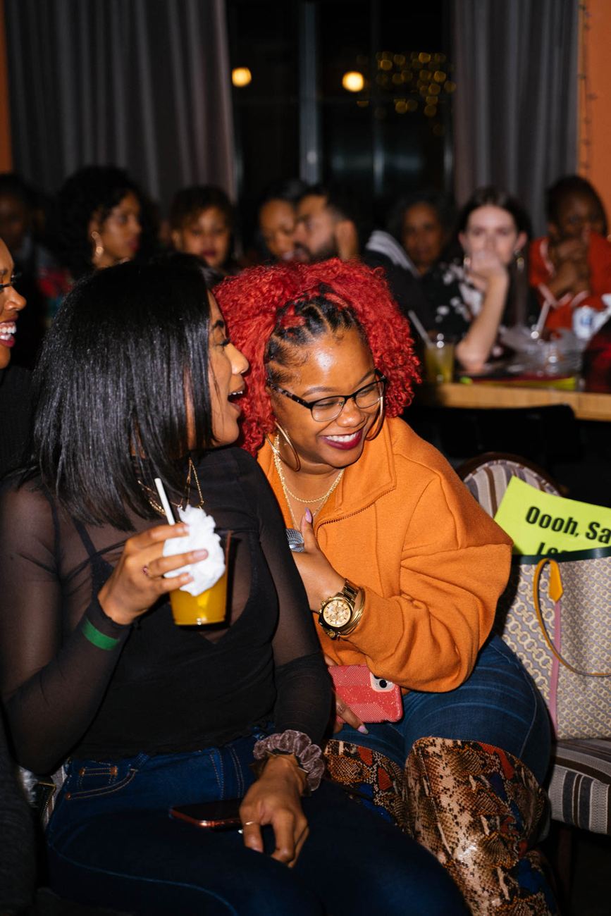 Two guests laughing at their table