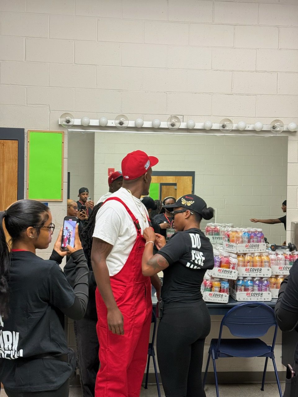 Backstage: a DOTHEWORK crew member fitting Mr. Prather’s mic