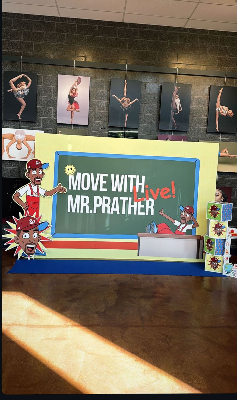 The Move With Mr. Prather Live! photo backdrop set up in the lobby