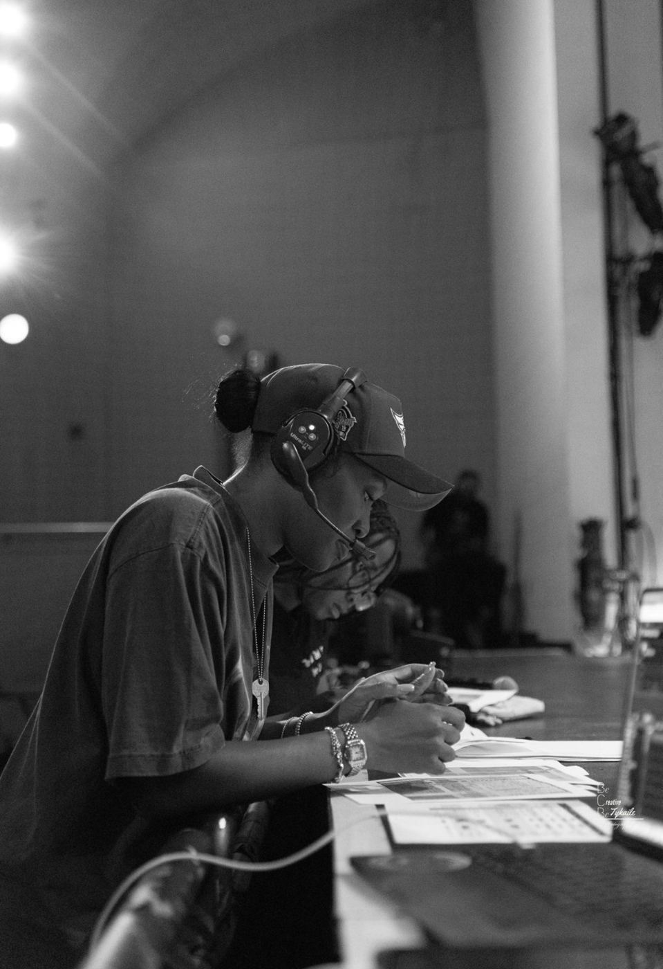Aja on headset at the production table, working through the show paperwork