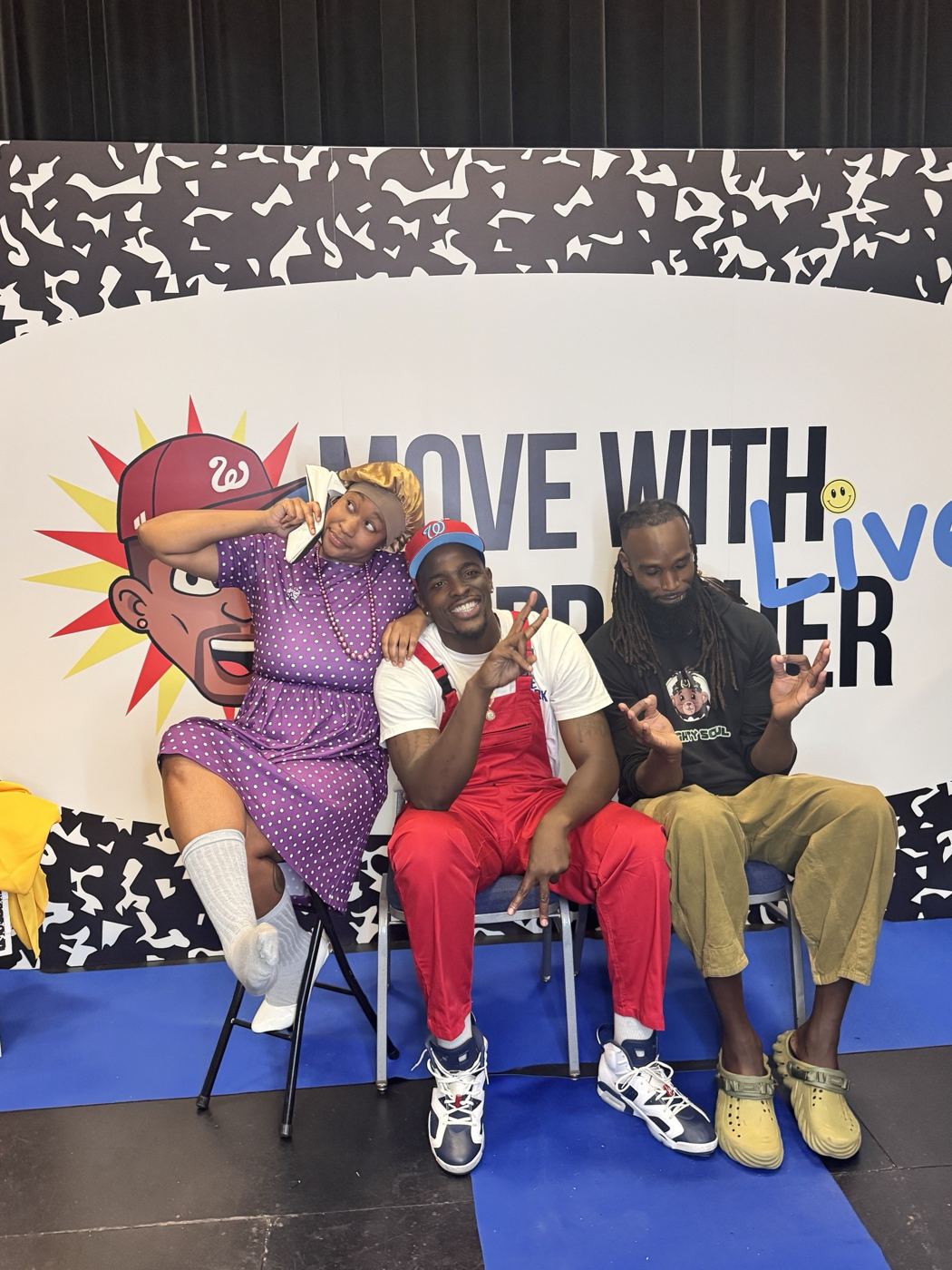 Mr. Prather and two cast members clowning in front of the Move With Mr. Prather Live! backdrop